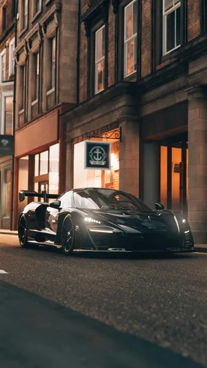 Sleek_ Black_ Supercar_ Evening_ Cityscape.jpg Wallpaper