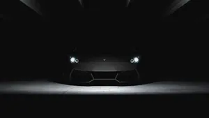 Sleek Oled Monitor On A Modern Desk Wallpaper