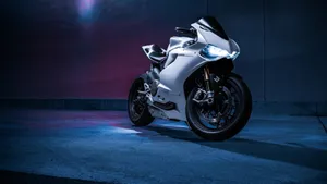 Sleek Red Ducati Motorcycle On A Scenic Route Wallpaper