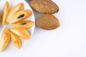 Slices Of Sapodilla Fruits On Plate Wallpaper
