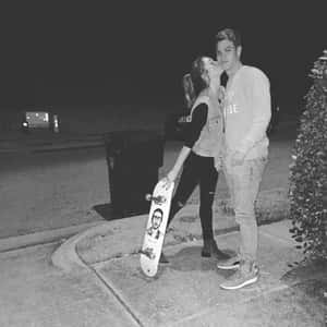 Smiling Couple Sharing A Romantic Moment Together Wallpaper