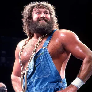 Smiling Wrestler With Chainand Overalls Wallpaper