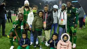 Soccer Champions Celebrationwith Familyand Trophy Wallpaper