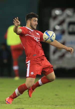 Soccer Player Controling Ball During Match.jpg Wallpaper