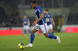 Soccer Player Controling Ball During Match Wallpaper