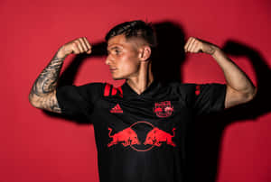 Soccer Player Flexingin Red Bull Jersey Wallpaper