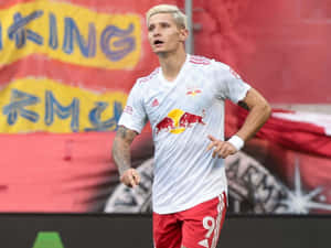 Soccer_ Player_ In_ Action_ On_ Field.jpg Wallpaper