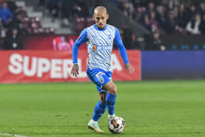 Soccer_ Player_in_ Action_on_ Field.jpg Wallpaper