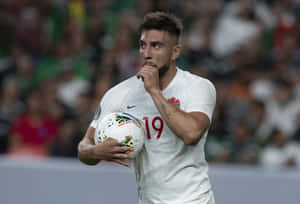 Soccer Player Thoughtful Moment During Match Wallpaper