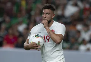 Soccer Player Thoughtful Moment During Match Wallpaper