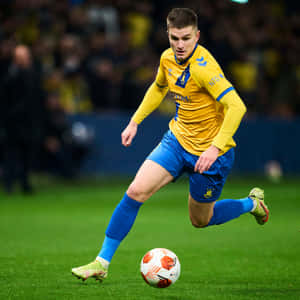 Soccer Playerin Action Dribbling Wallpaper