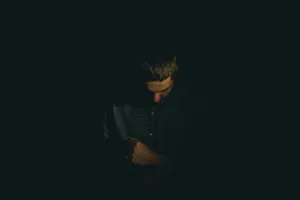 Solitude In Shadows - A Portrait Of A Sad Boy Wallpaper