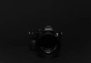 Sony Dslr Camera On Black Desktop Wallpaper