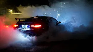 Sophisticated Bmw Laptop With Smoke Effect Background Wallpaper