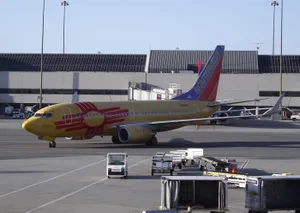 Southwest Airlines Yellow Airplane In Flight Wallpaper