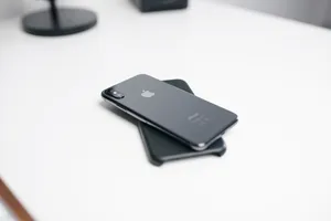 Space Gray Iphone X On White Surface Wallpaper