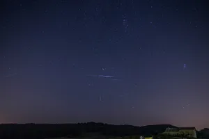 Spectacular Meteor Shower Across The Night Sky Wallpaper
