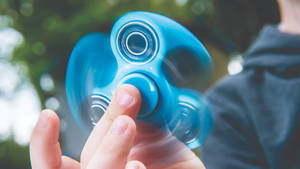 Spinning Blue Fidget Toy Wallpaper