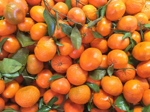 Stack Of Clementine Fruits Top View Wallpaper