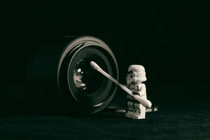 Star Wars Storm Trooper Minifig Holding Cotton Swab Cleaning Camera Lens Wallpaper