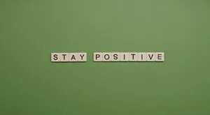 Stay Positive Scrabble Word On Green Background Wallpaper