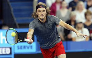 Stefanos Tsitsipas Running After Tennis Ball Wallpaper