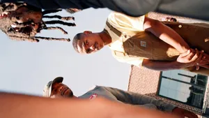 Steve Lacy Wearing Brown Overalls Wallpaper