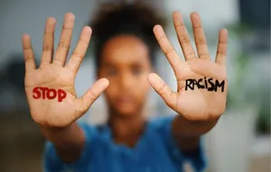 Stop Racism Written On Both Hands Wallpaper