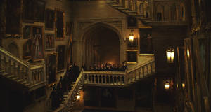 Students Running Up And Down The Staircase At Hogwarts Wallpaper