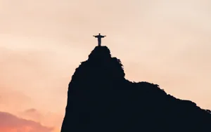 Stunning Christian Macbook On A White Desk Wallpaper