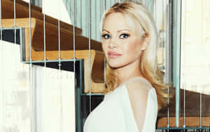 Stunning Pamela Anderson Posing For A Photoshoot Wallpaper