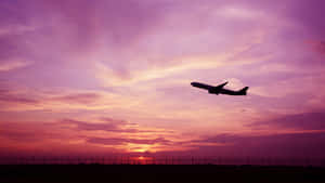 Stunning Pink Airplane Gliding Through The Sky Wallpaper