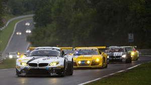 Stunning Sports Cars In Thrilling Race Wallpaper