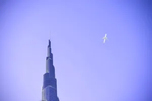 Stunning View Of Burj Khalifa With Plane In Sky Wallpaper