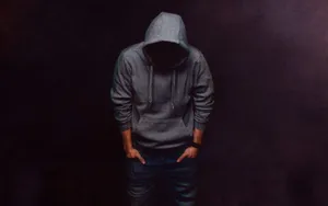 Stylish Man In Hoodie Embodying Urban Cool Wallpaper