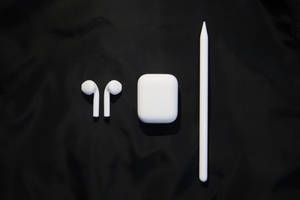 Stylish White Airpods With Accessories Wallpaper