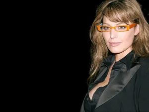 Stylish Womanin Orange Glassesand Black Blazer Wallpaper