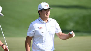 Sungjae Im Smiling And Holding A Ball Wallpaper