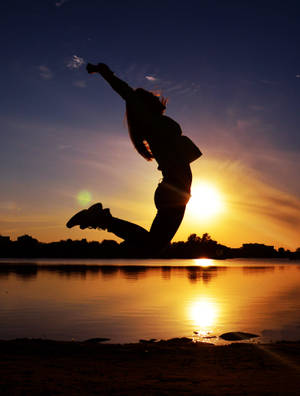 Sunset Silhouette Jumping Wallpaper