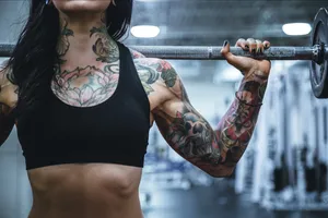 Tattooed Woman With Barbell Wallpaper