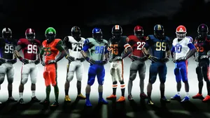 Teams In Vibrant Football Uniforms Wallpaper