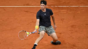 Tennis Player Intense Forehandon Clay Court Wallpaper