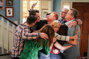 The Cast Of Modern Family Celebrating The Finale With A Group Hug. Wallpaper