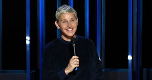 The Ellen Show Host Holding Mic Wallpaper