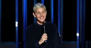 The Ellen Show Host Holding Mic Wallpaper