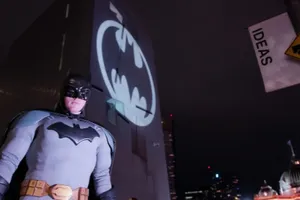 The Iconic Bat Signal Lighting Up The Night Sky Wallpaper