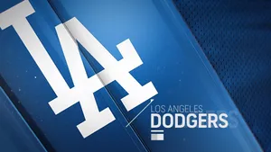 The Iconic Los Angeles Dodgers Logo Against A Vivid Blue Background. Wallpaper