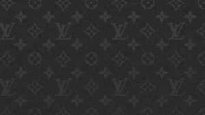 The Iconic Louis Vuitton Logo Atop A Brown Desktop Wallpaper