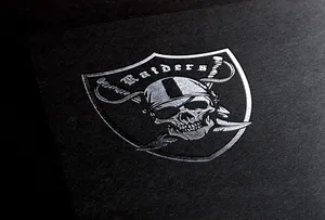 The Iconic Silver And Black Raiders Logo Wallpaper