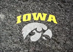 The Irresistible Strength Of The Iowa Hawkeyes Captured In A Striking Image. Wallpaper